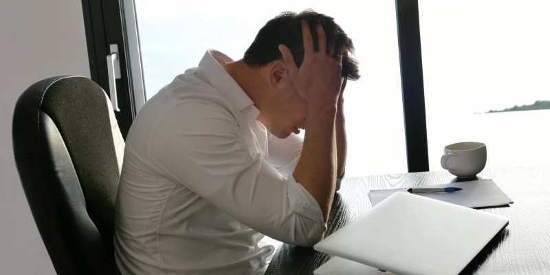 frustrated with problems young business man working on laptop computer at home